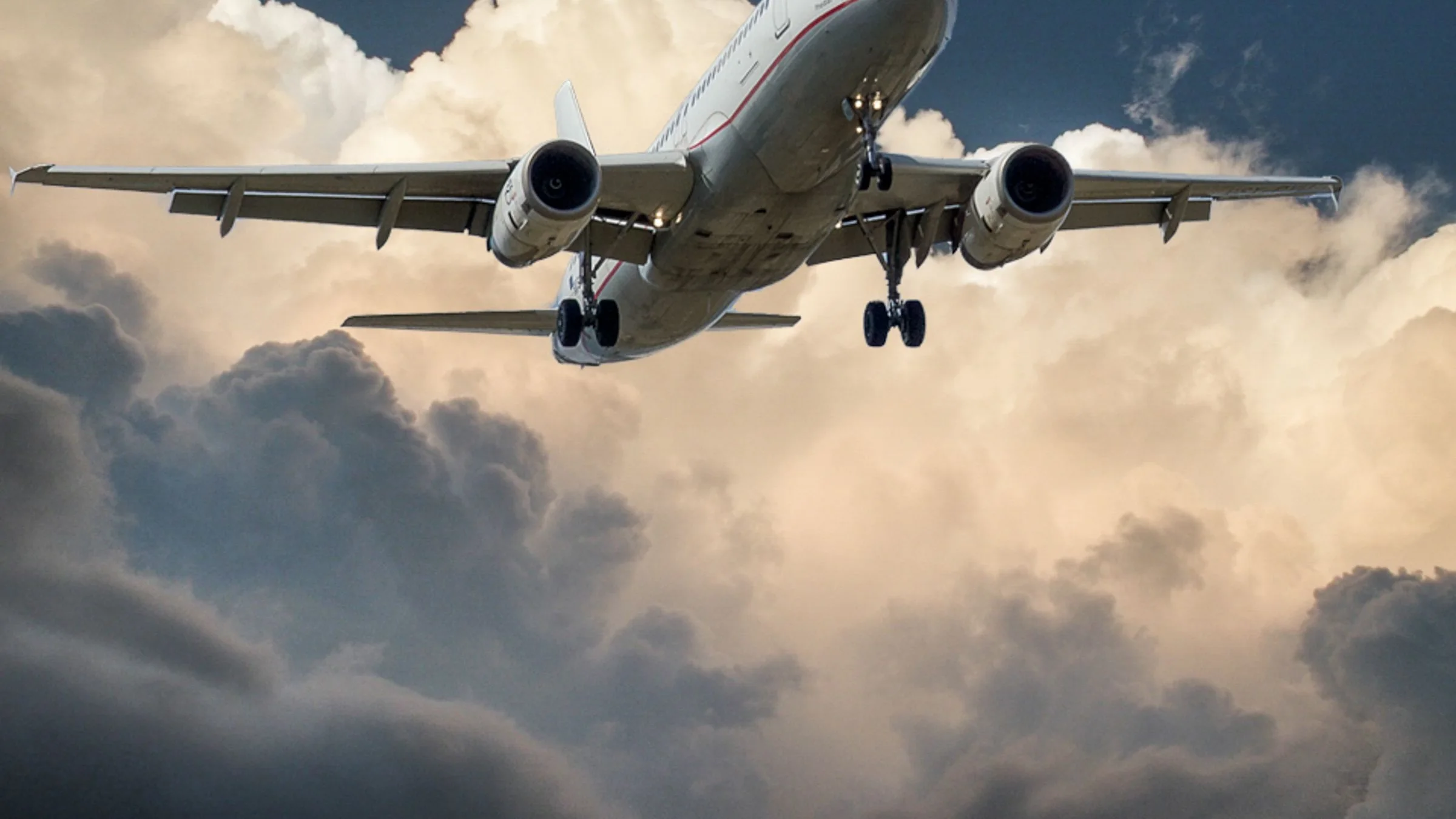 Passenger jet lifting off into a vivid blue sky
