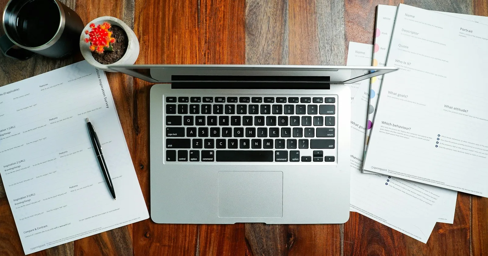Booking paperwork and a laptop on a desk